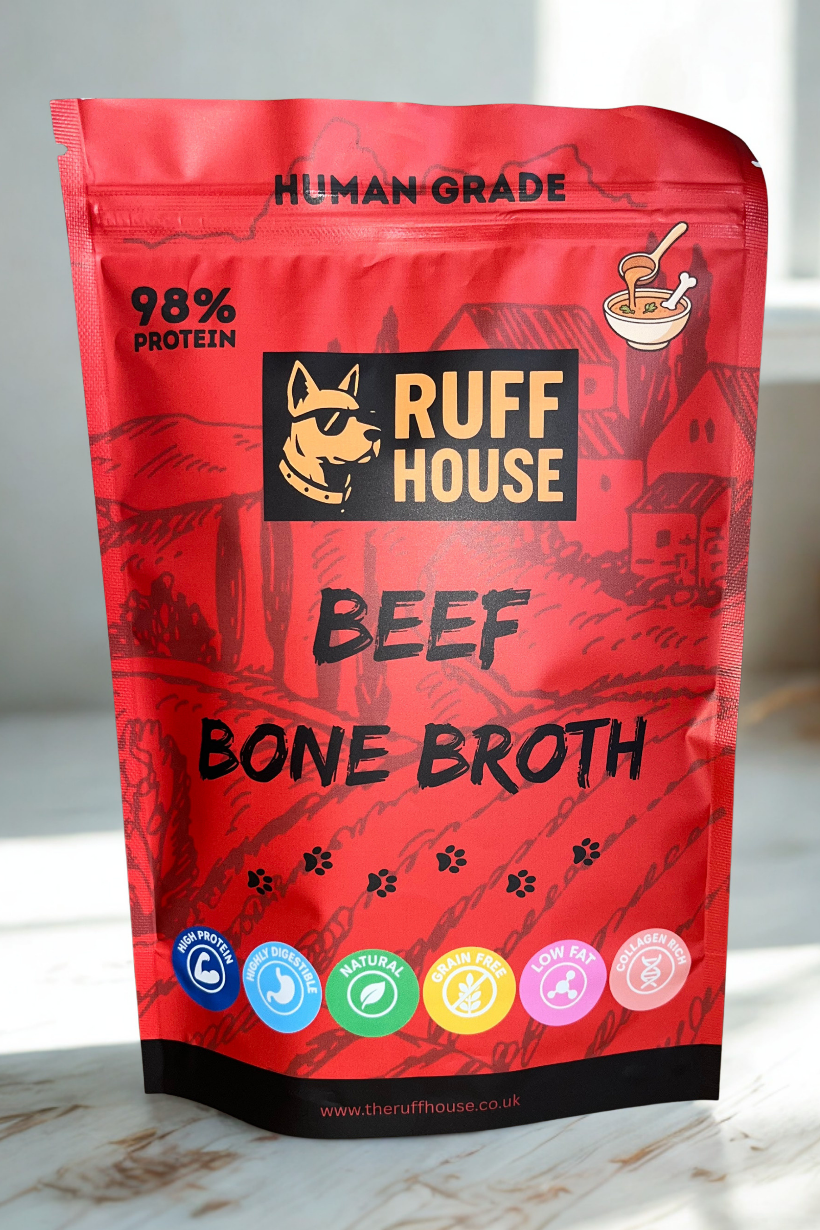 Ruff House Beef Bone Broth front of pack showing the red human grade 98 percent protein powder topper designed to boost hydration, support joints, and add savoury beef flavour to dog meals.