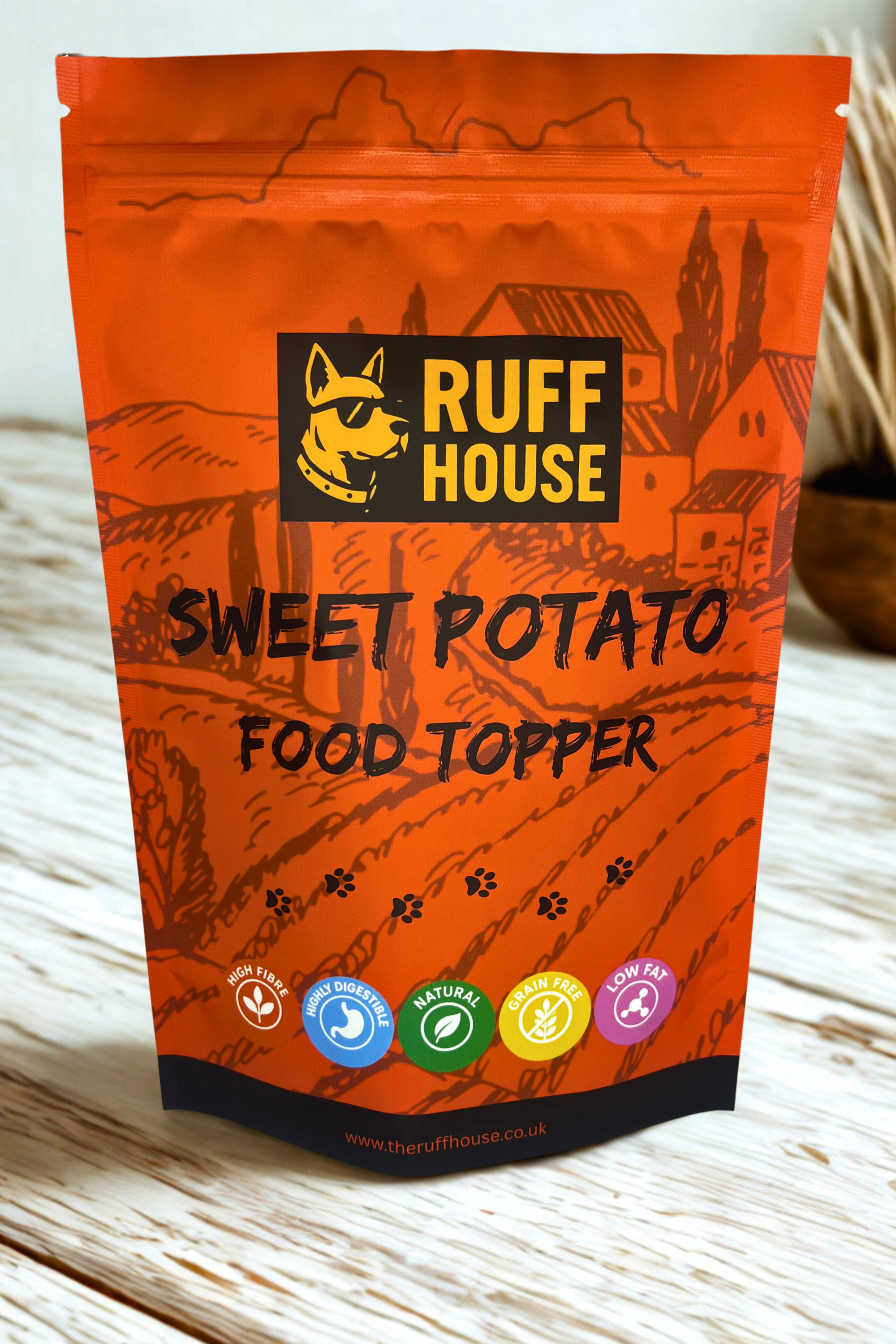 Ruff House Sweet Potato Food Topper front of pack showing the orange pouch with high fibre, digestible, natural, grain free and low fat benefits.
